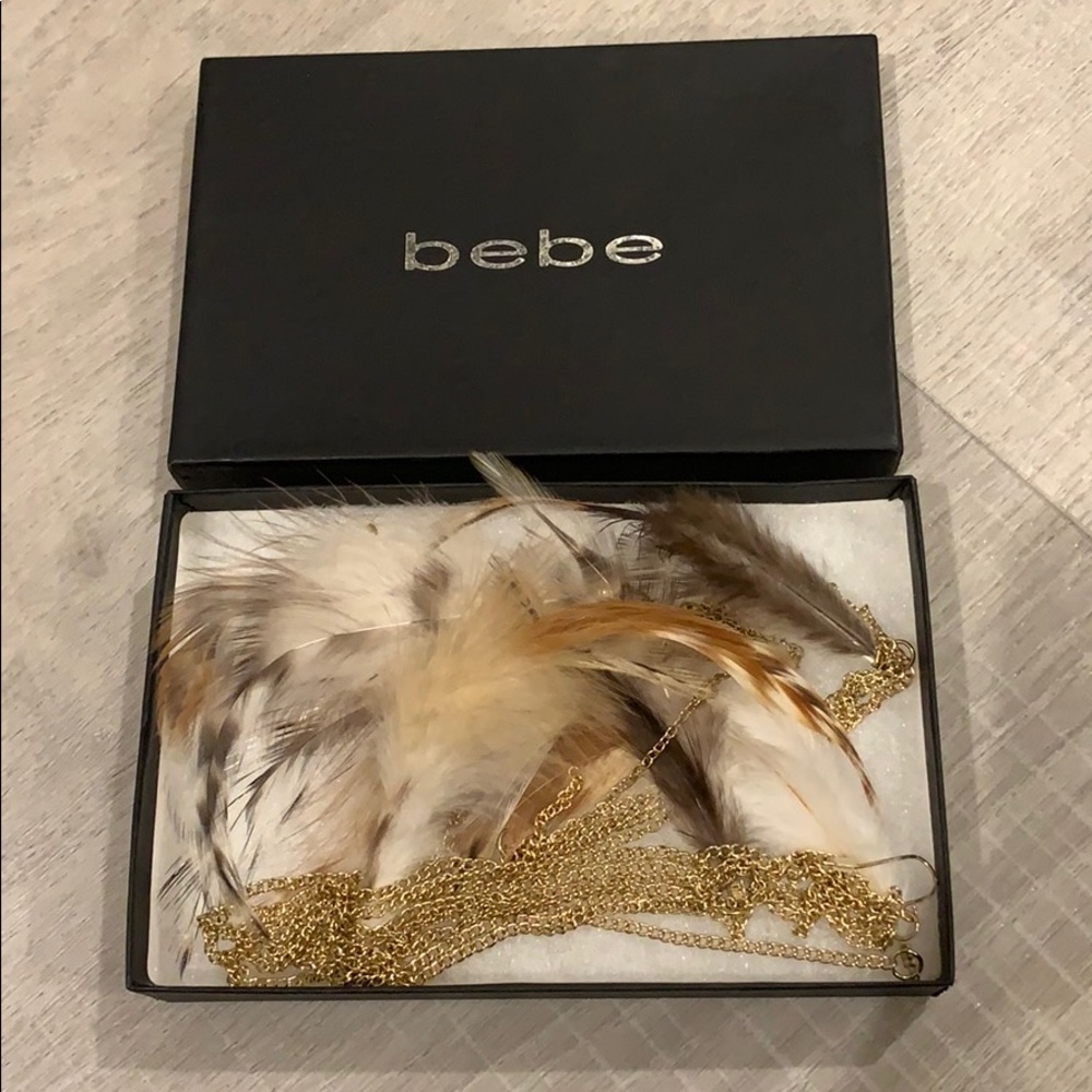 Bebe asymmetrical feather earring